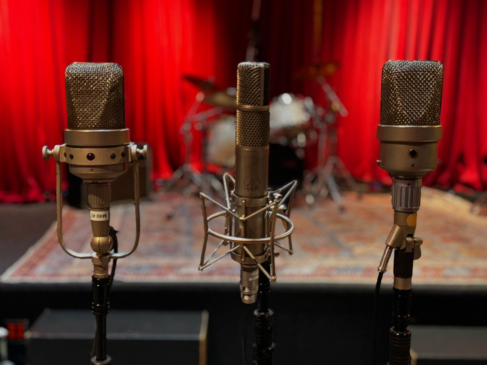 Two Neumann M-49 tube microphones flanking an AKG C-24 stereo tube microphone on the Live Room stage — Clearmountain's Berkeley Street Studios Santa Monica